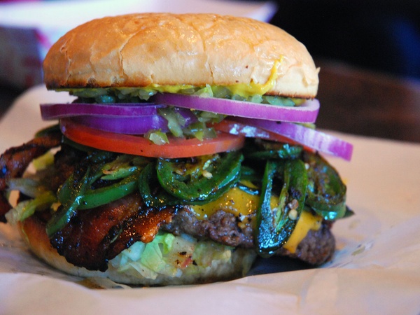 Cheeseburger with bacon and jalapeños at Maple & Motor in Dallas