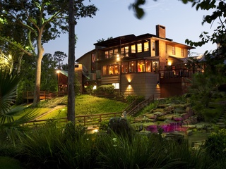 Brenner's Steakhouse on the Bayou exterior night landscaping