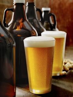 Glass of beer and growlers