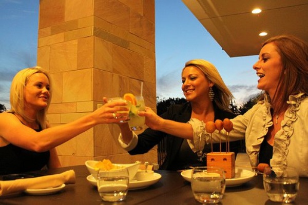 Americas River Oaks, patio dining, women toasting.jpg
