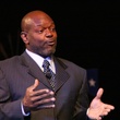 Emmitt Smith, in suit, speaking