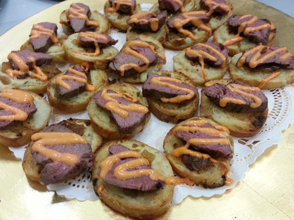 Wedding food trends, February 2013, Filet Canapés with Housemade Boursin, Caramelized Onions and Red Pepper Aioli, from A La Carte Catering & Events