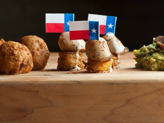 Lonesome Dove Austin restaurant first course rattlesnake sausage Texas flag