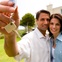 couple holding keys to new house