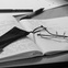 writing a book, glasses, notebook, pen