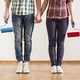Man and woman holding paint brushes