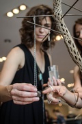 Margot Wolf shows on of her pieces to fellow artist Cambria