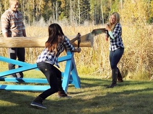 Girls cut logs on the Bachelor